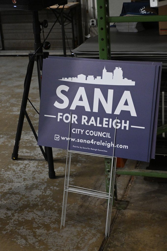 Event signs around the room at the October 2026 Wake Dems event